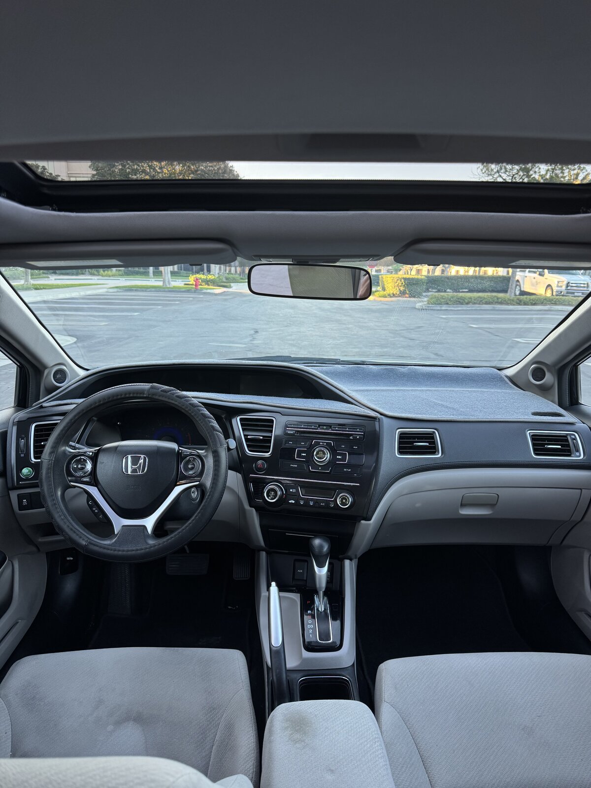 2013 Honda Civic EX dashboard, steering wheel and center console with sunroof open