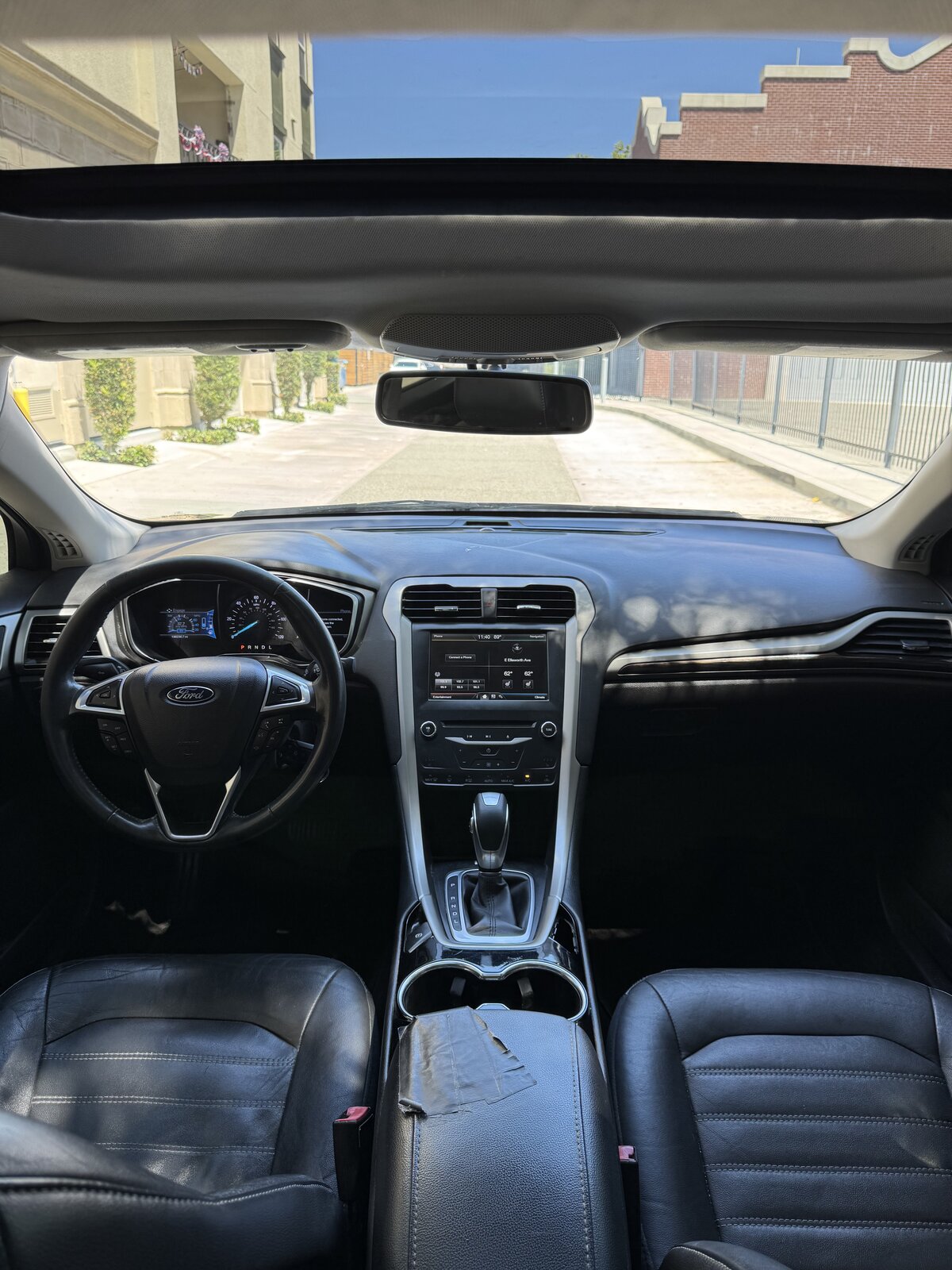 2014 Ford Fusion Hybrid dashboard and center console with sunroof open
