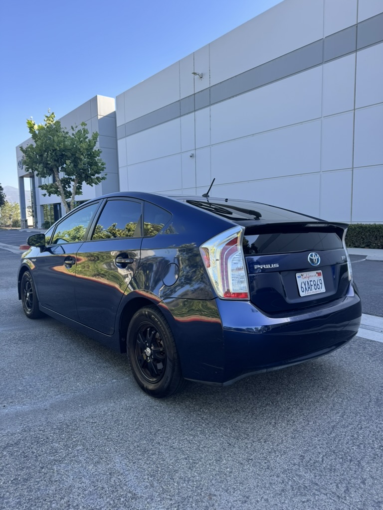Blue 2012 Toyota Prius rear driver-side three-quarter view showing hatchback