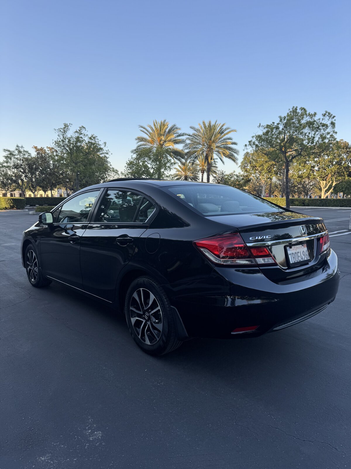 Black 2013 Honda Civic EX rear driver-side three-quarter view