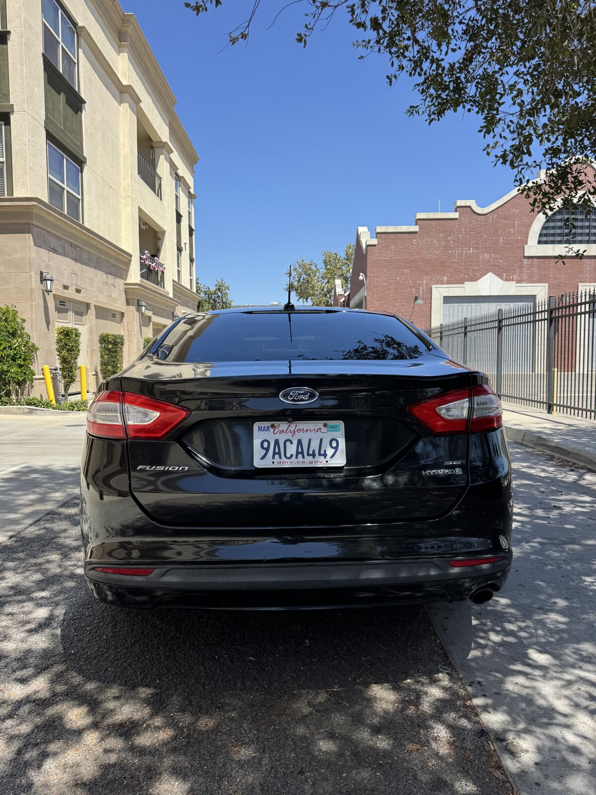 Black 2014 Ford Fusion Hybrid straight-on rear view
