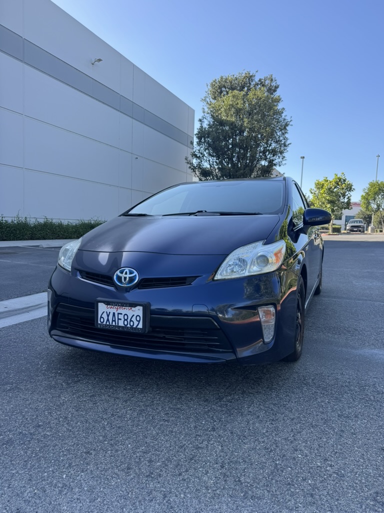 Blue 2012 Toyota Prius front driver-side three-quarter view in parking lot